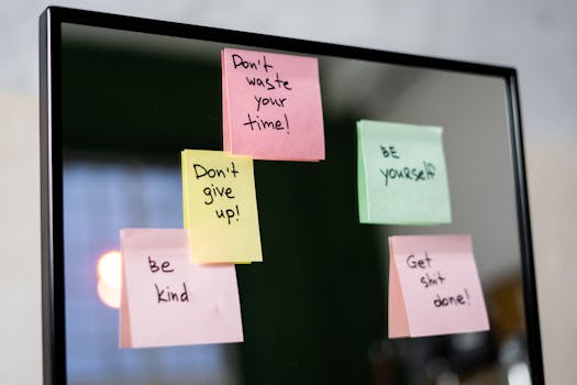 Colorful sticky notes with motivational messages on a mirror reflecting positivity.